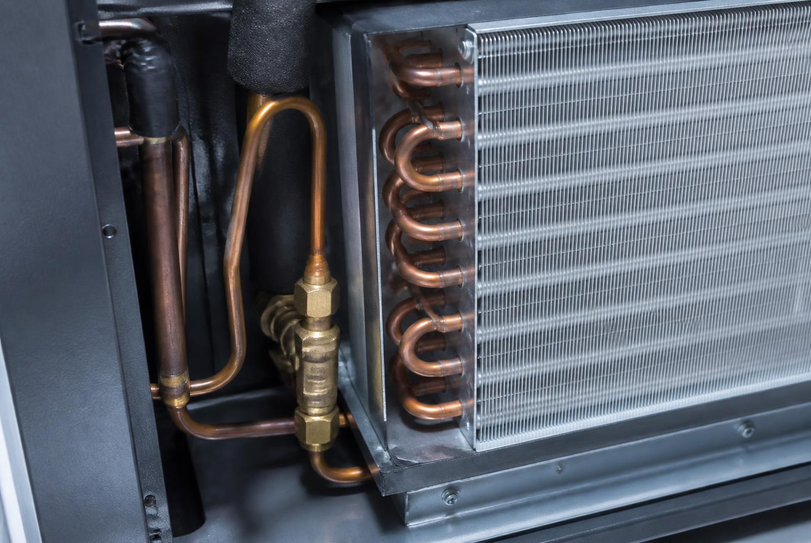 Copper refrigerant lines and evaporator coil inside an HVAC air handler